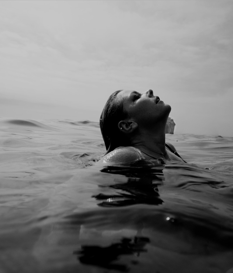 Girl in the ocean practising her Breath Work